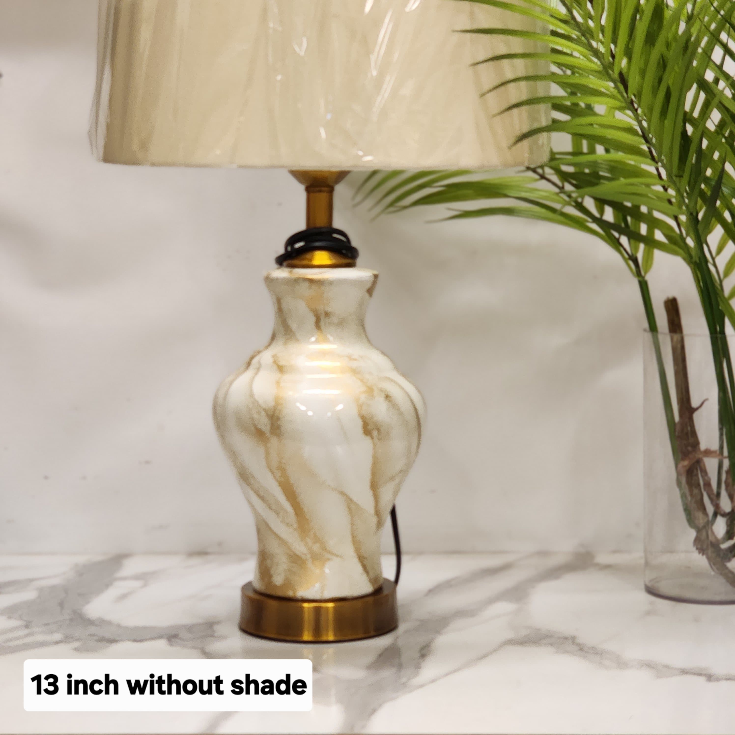 marble-finish ceramic table lamp with a brass base