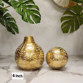 gold tear-drop / bulbous vase with an etched white leaf
