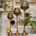 Moroccan-style metal filigree pedestal candle holders
