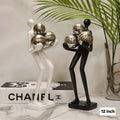 Minimalist Humanoid Figurine Holding Chrome Orbs