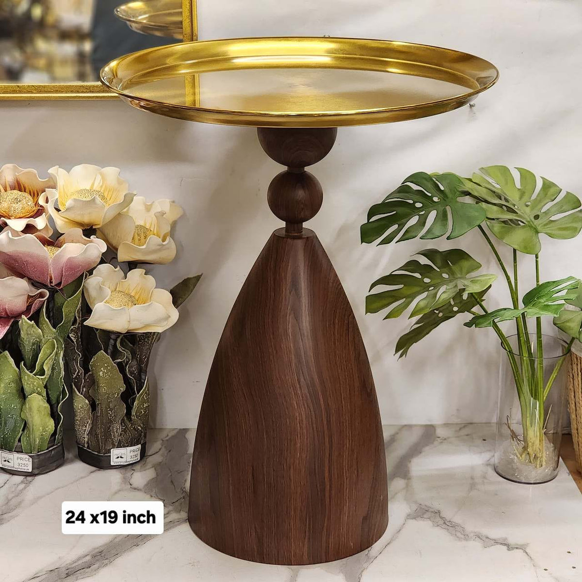 pedestal side table with a brass metal tray top and wooden conical/sculptural base.
