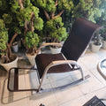 outdoor woven rattan rocking chair with a footrest