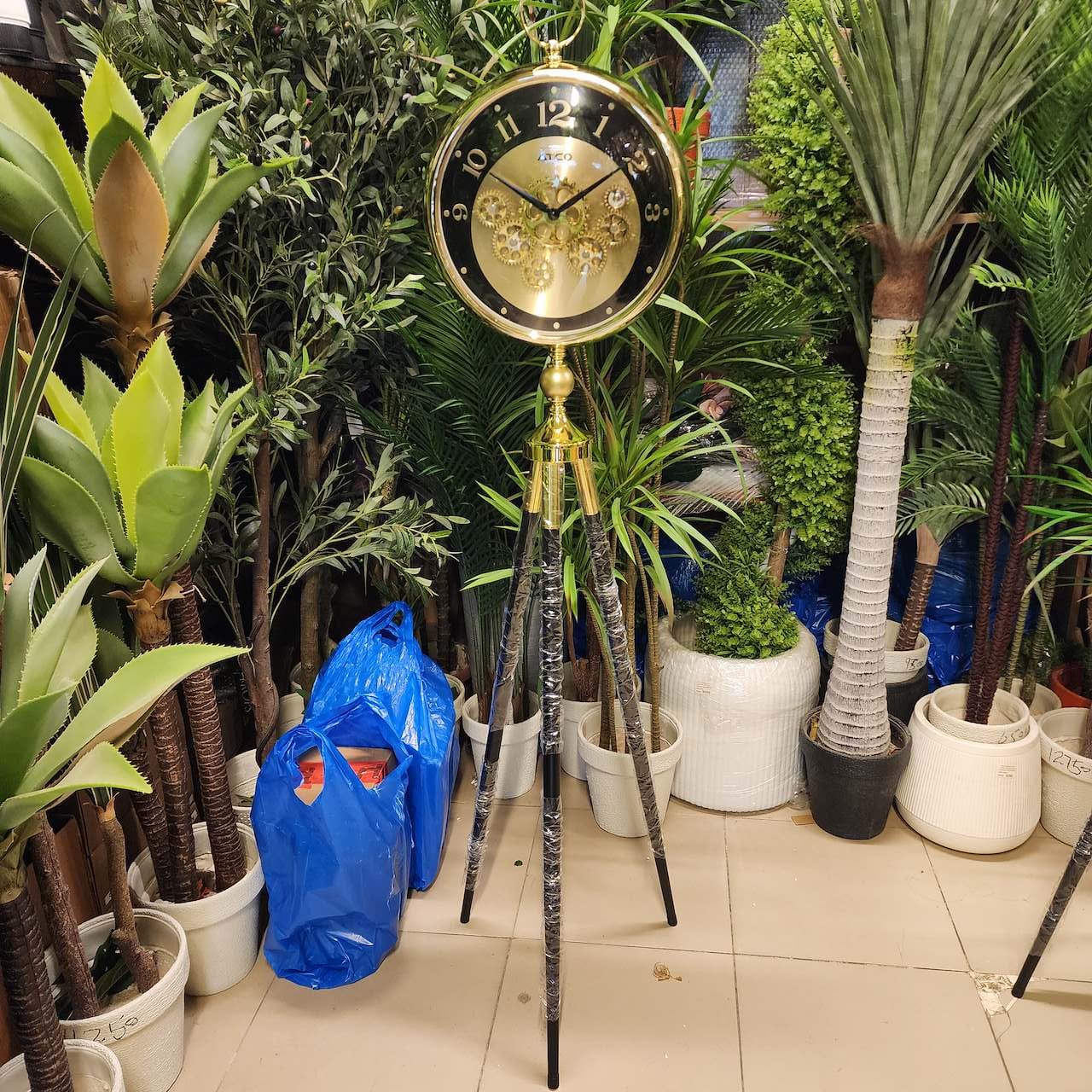 vintage industrial moving gear tripod floor clock
