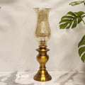 vintage brass hurricane lamp with an etched glass chimney