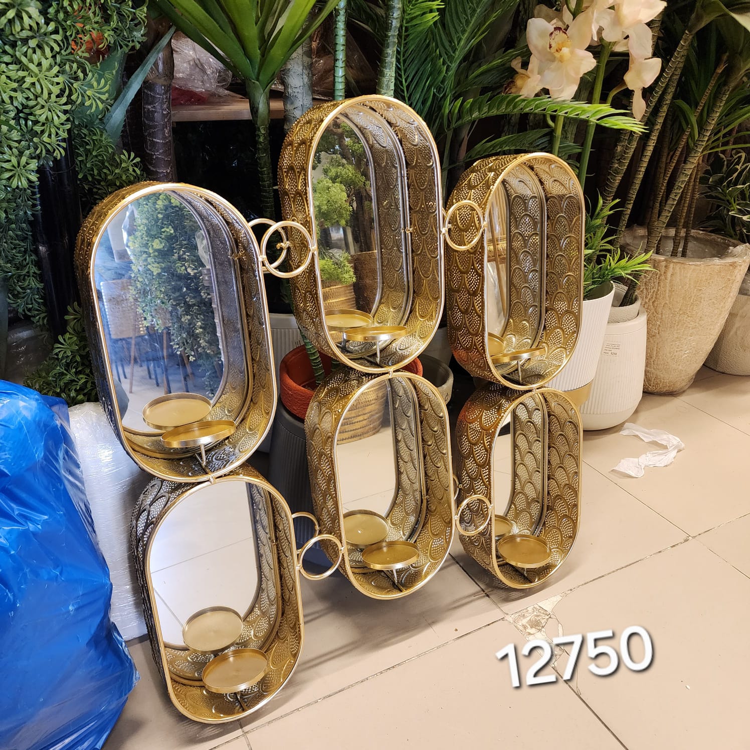 Hollywood Regency style interconnected pill-shaped wall mirror with built-in candle holders